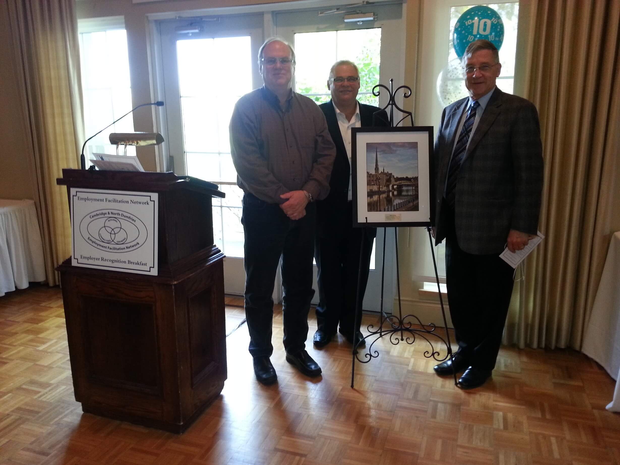 Canadian artist, Alex Krajewski with the President of Cambridge Chamber of Commerce, Greg Durocher and Regional Chair, Ken Sailing