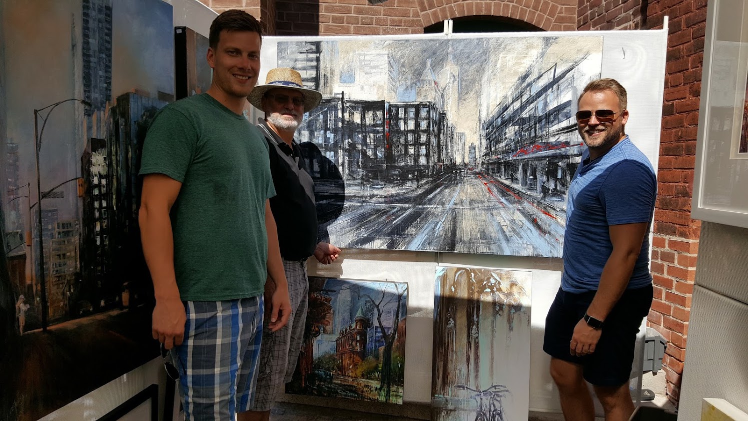 Canadian artist Alex Krajewski at an ArtFest at Destillery in Toronto Ontario with happy customers