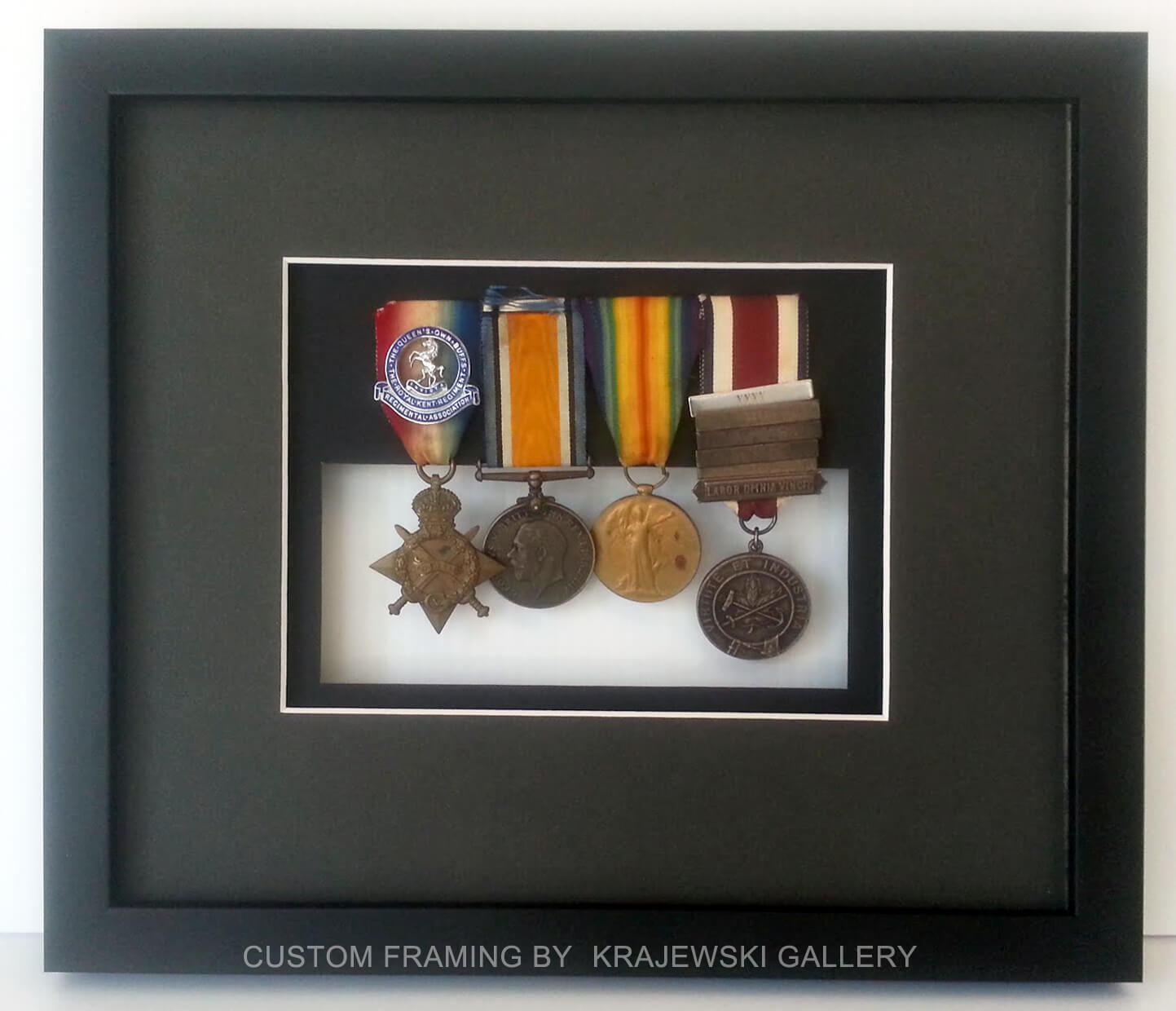 Custom Picture Framing by Krajewski Gallery: World War 2 medals custom framed with glass in the back showing off the other side