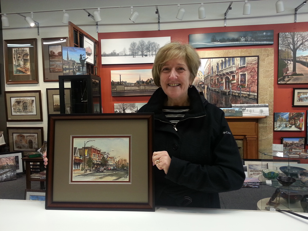 Happy customer with the framed commissioned painting by Alex Krajewski of her home in Preston