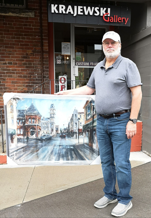 Alex Krajewski delivers a finished commission painting to his gallery in Cambridge Ontario