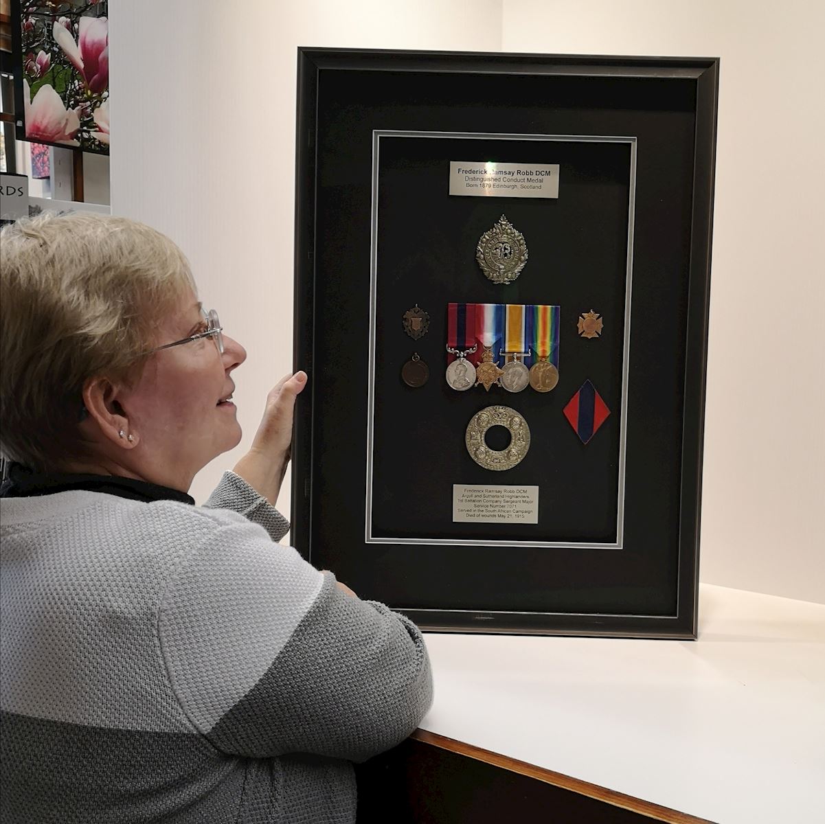 Customer enjoying her family treasures framed by Krajewski Gallery 