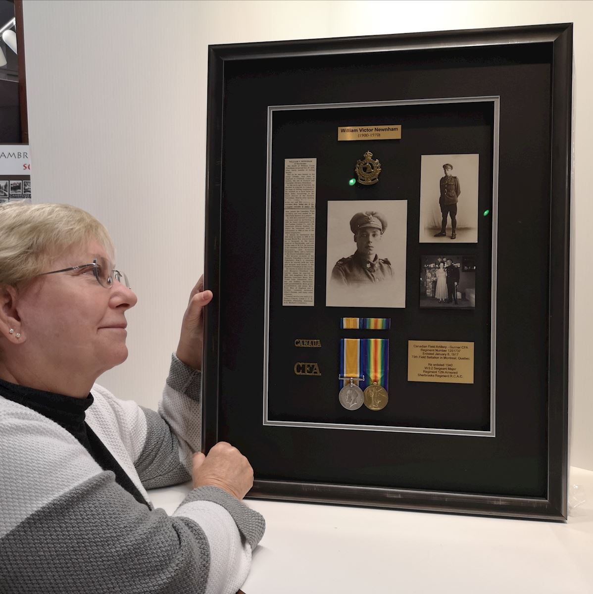 Customer enjoying her family treasures framed by Krajewski Gallery 