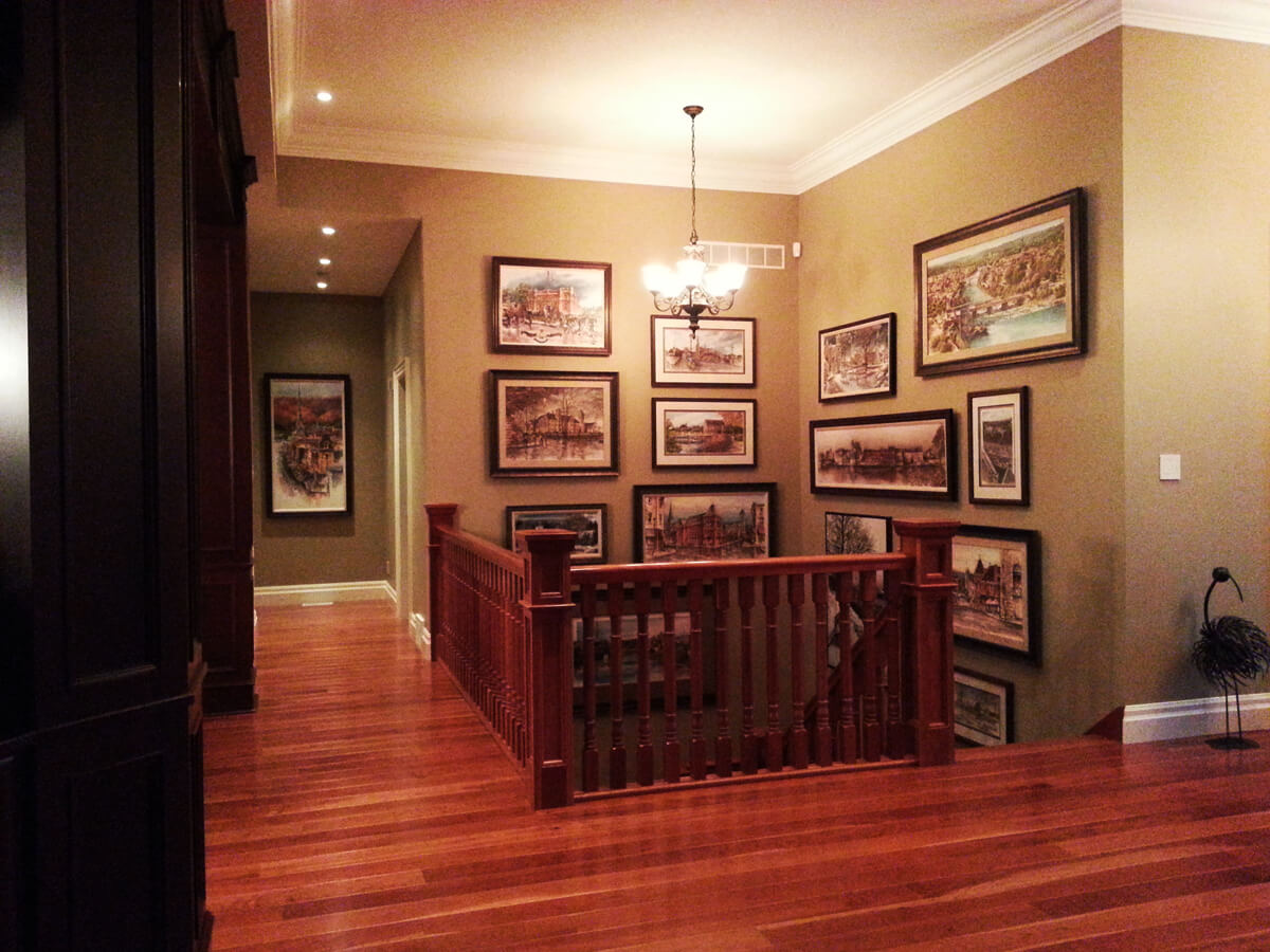 Instalation of Alex Krajewski's collection of framed prints of Cambridge Ontario at a home in St. George